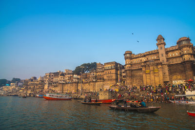 Boats in canal along buildings