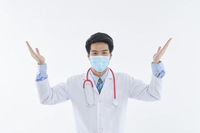 Portrait of senior man standing against white background
