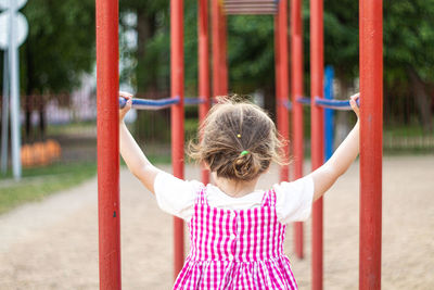 Rear view of girl playing in park