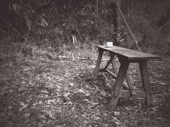 Empty chairs and table on field