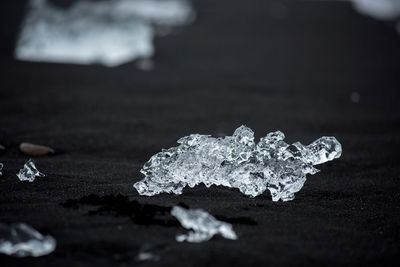 Ice blocks on diamond  beach, sea waves, black sand. jokulsarlon. atlantic ocean coast, iceland