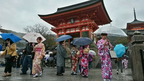 People on multi colored umbrellas against sky