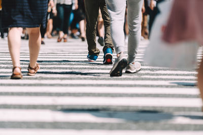 Low section of people walking on road