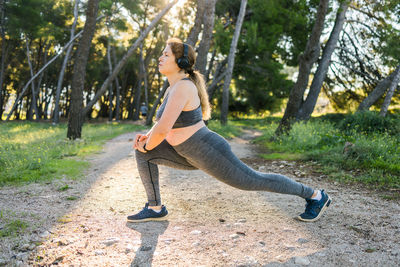 Full length of woman exercising in park