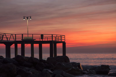 Scenic view of sea against orange sky