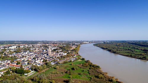 High angle view of buildings against clear blue sky