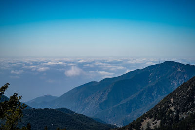 Scenic view of mountains against clear blue sky