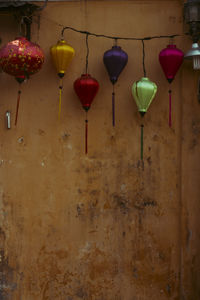 Low angle view of illuminated lanterns hanging on wall