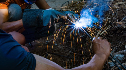 Low section of man holding fire