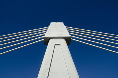 Low angle view of bridge against clear blue sky