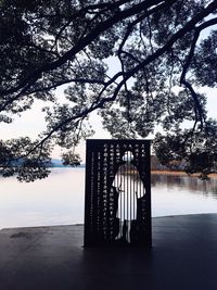 Gazebo by lake against sky