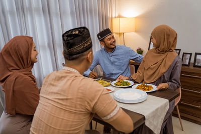 Happy couples having food at home