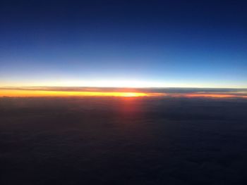 Aerial view of landscape against clear sky at sunset