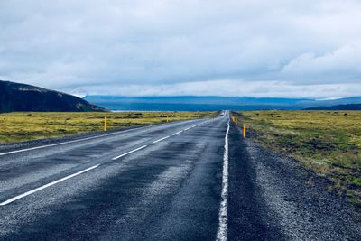 Empty road along countryside landscape