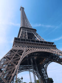 Eiffel tower shot upwards against blue sky