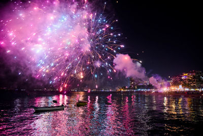 Low angle view of firework display at night