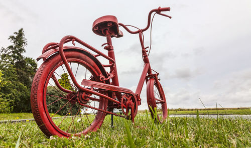 Bicycle on field against sky