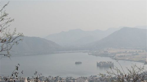 Scenic view of lake and mountains against sky