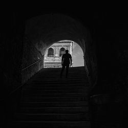 Low angle view of silhouette man standing on steps