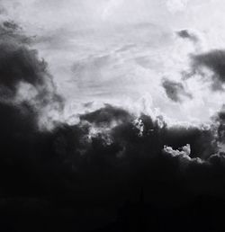 Low angle view of silhouette trees against sky