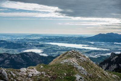 Scenic view of sea and mountains against sky