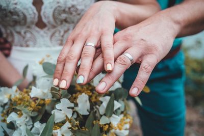 Midsection of bridegroom wearing wedding rings