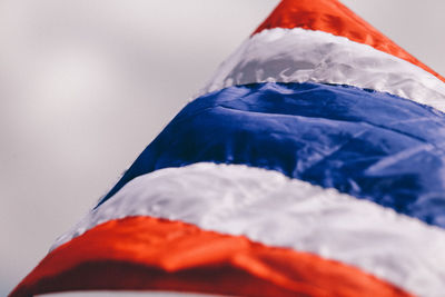 Low angle view of flag against blue sky