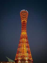 Low angle view of illuminated tower against sky