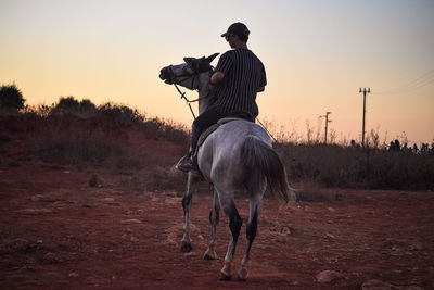 Full length of man riding horse