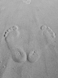 High angle view of footprints on sand at beach