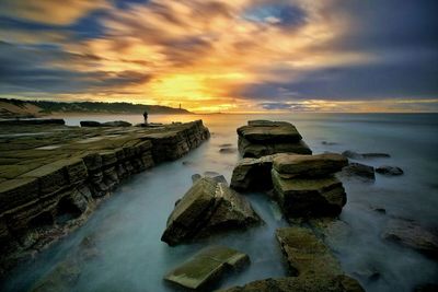 Scenic view of sea against cloudy sky