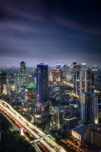 High angle view of city lit up at night