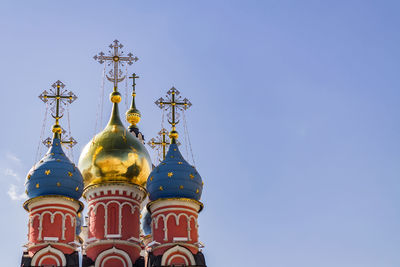 Low angle view of bell tower against blue sky