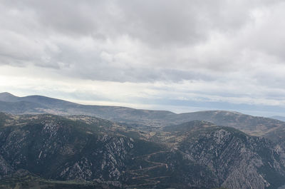 Scenic view of mountains against cloudy sky