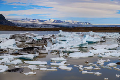 Frozen lake against sky during winter