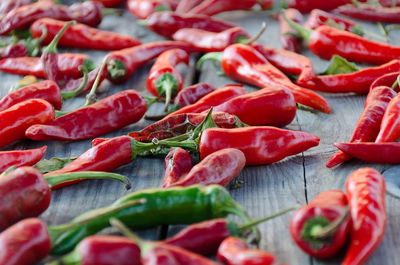 Raw organic chili red peppers dried on a wooden table. photo with shallow depth of field.