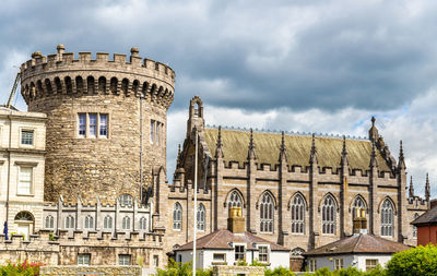 Historical buildings against cloudy sky