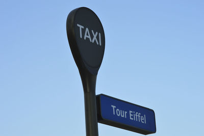 Low angle view of road sign against clear sky