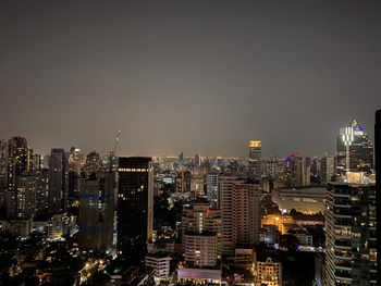 Illuminated bangkok cityscape against sky at night
