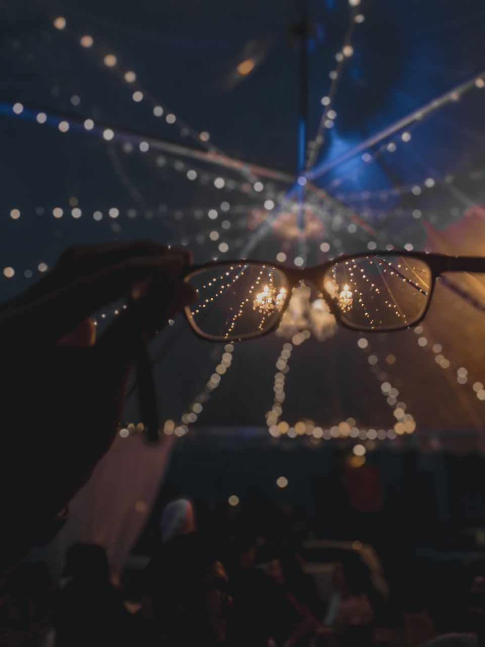 CLOSE-UP OF HAND HOLDING ILLUMINATED LIGHTS