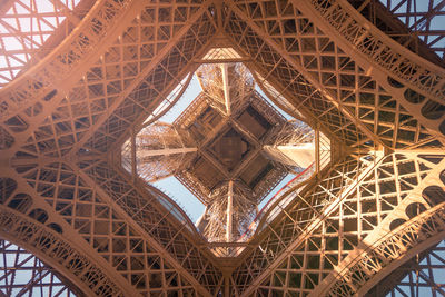 From below of observation tower with support posts and symmetrical decor on sunny day in paris france