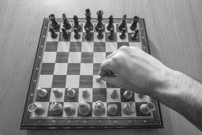 High angle view of man playing on chess board