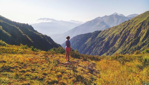 Full length of woman standing on mountain