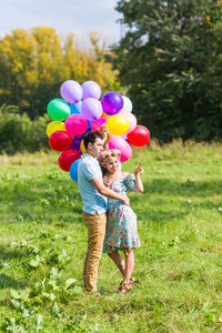 Rear view of girl holding balloons