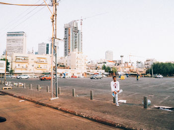 Woman standing on city street