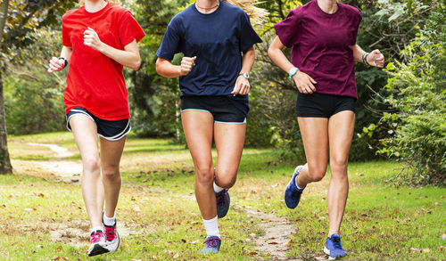 Low section of people running on grassland