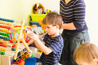 Rear view of people with toy toys