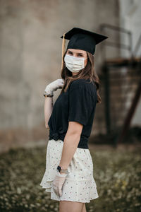 Portrait of woman wearing hat standing outdoors