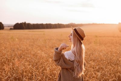 Rear view of woman standing on field