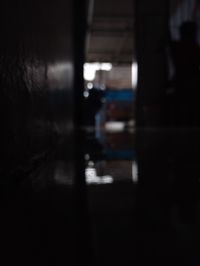 Defocused image of silhouette person in illuminated building